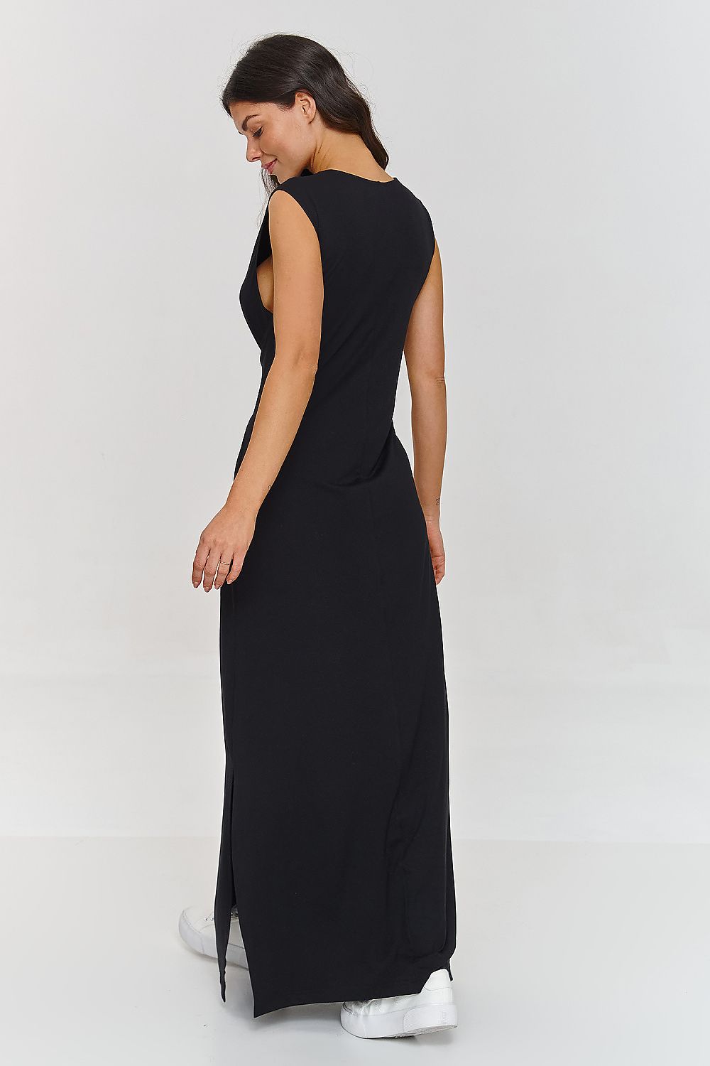Woman wearing a black sleeveless dress on a white background