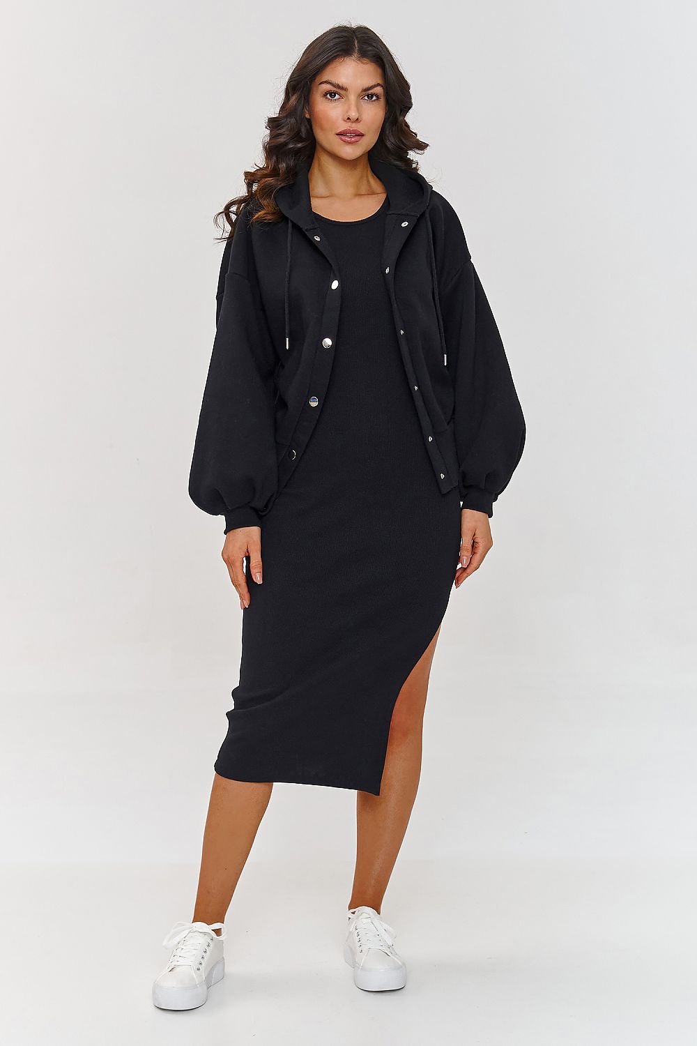 Woman wearing a black dress with a jacket on a white background
