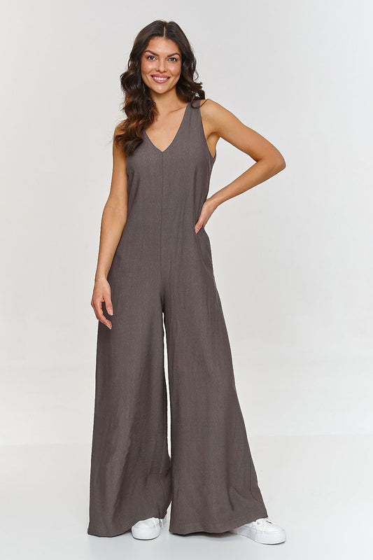 Woman wearing a brown jumpsuit on a white background