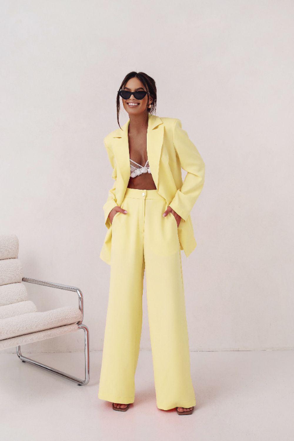 Person wearing a bright yellow suit with a white background