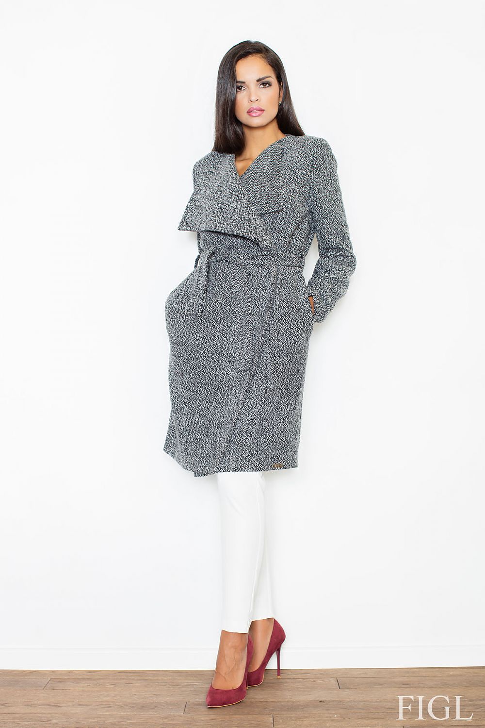 Woman wearing a gray textured coat with a white background