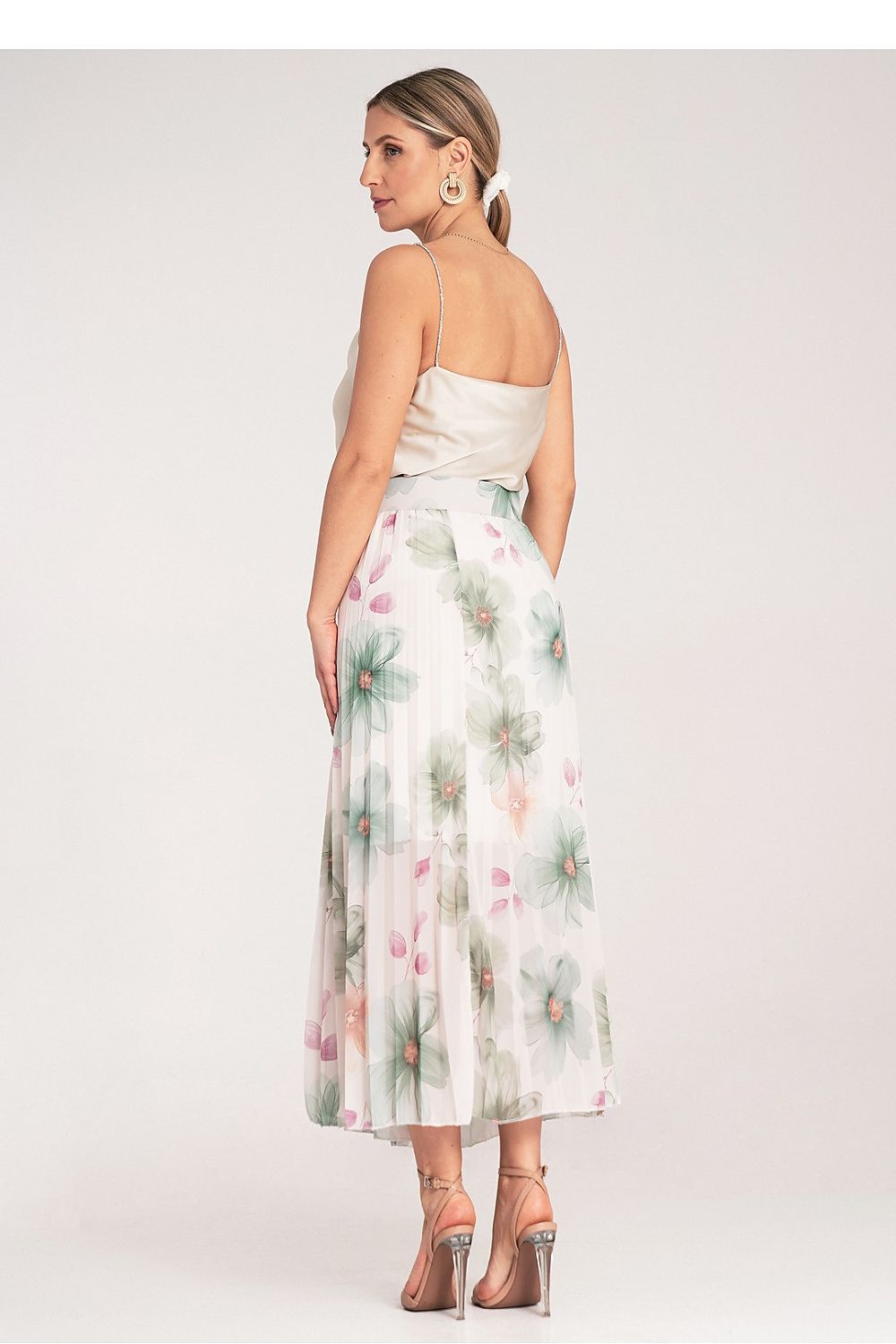 Woman wearing a floral dress on a white background