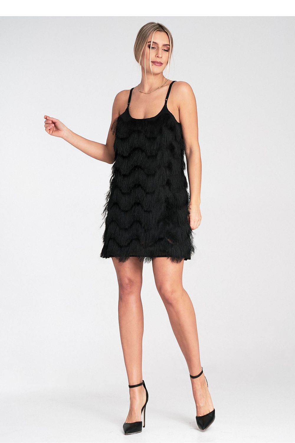 Woman wearing a black dress with feather details on a white background