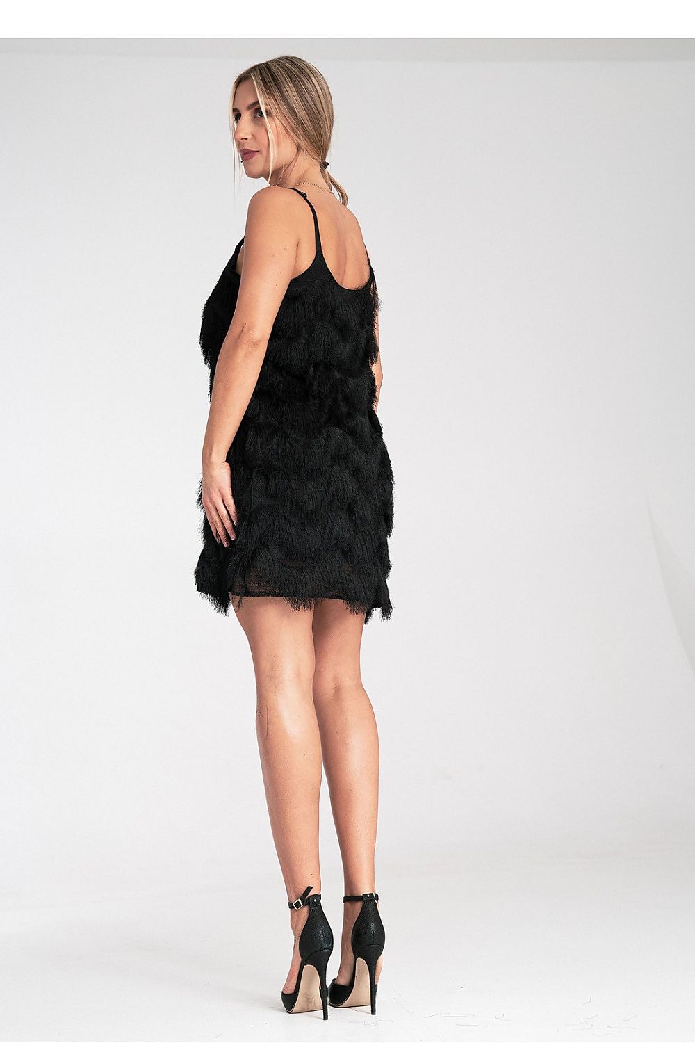 Woman wearing a black feathered dress on a white background
