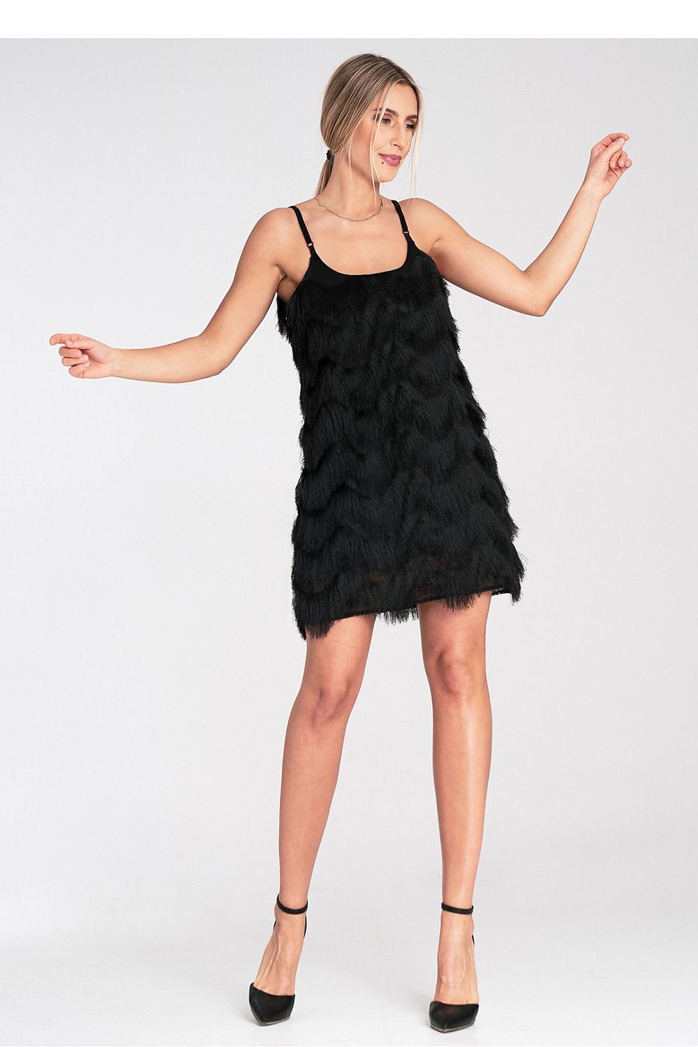 Woman wearing a black feathered dress on a white background