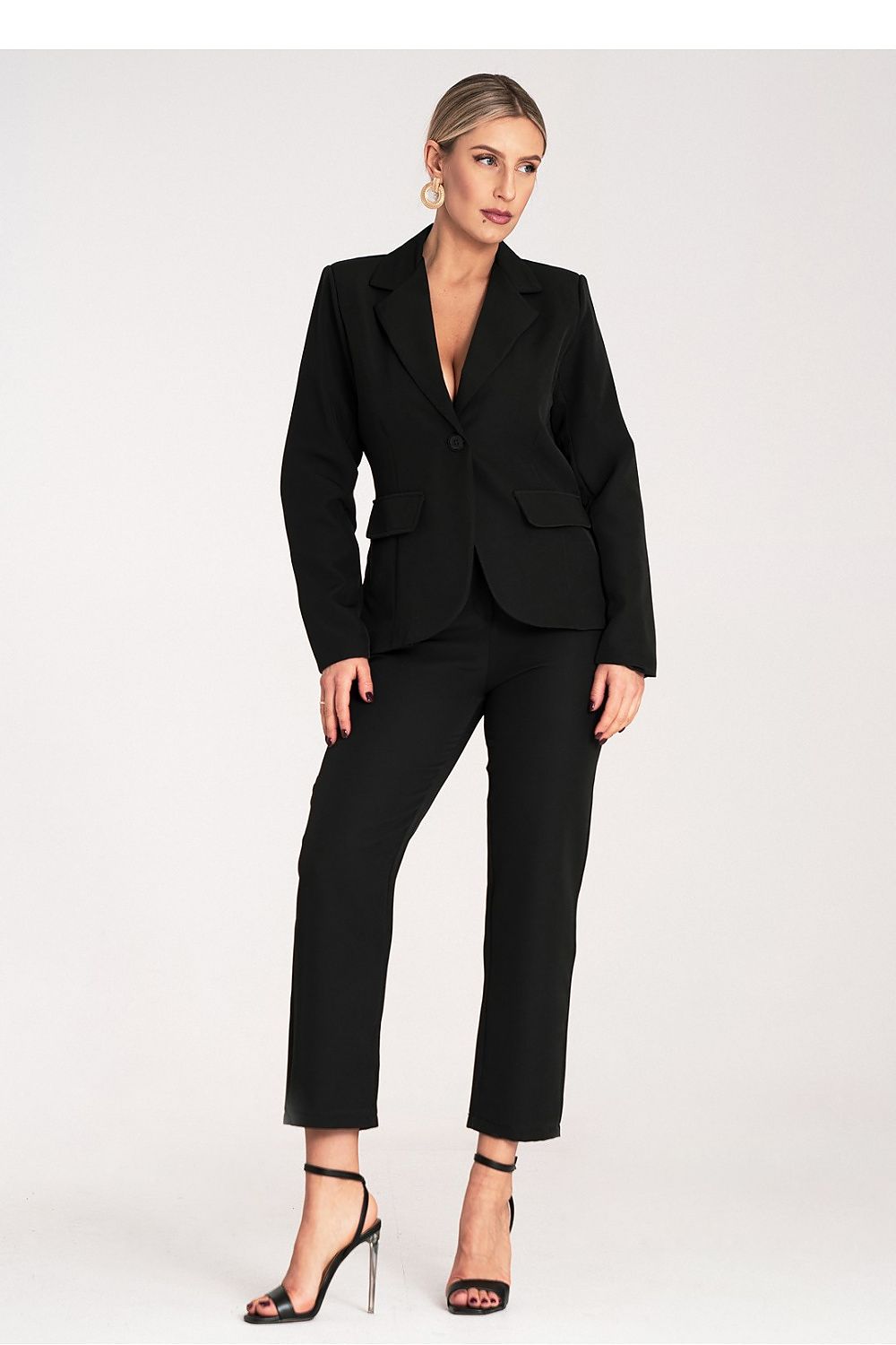 Woman wearing a black suit on a white background