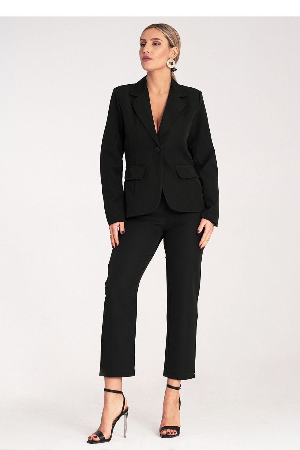 Woman wearing a black suit on a white background