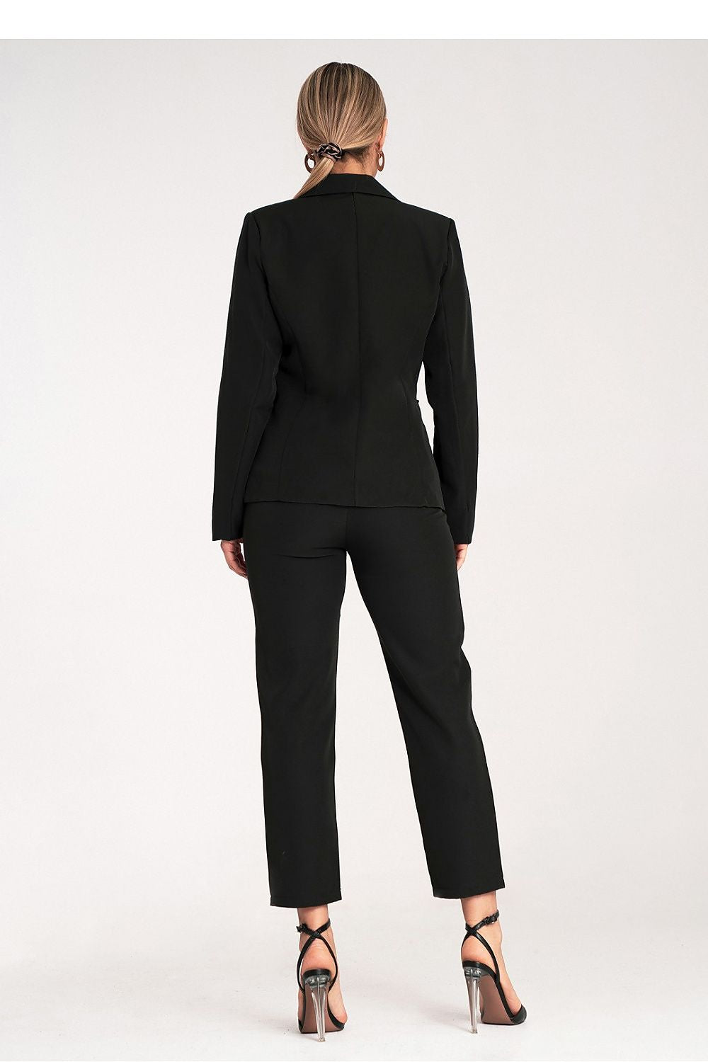 Person wearing a black suit on a white background