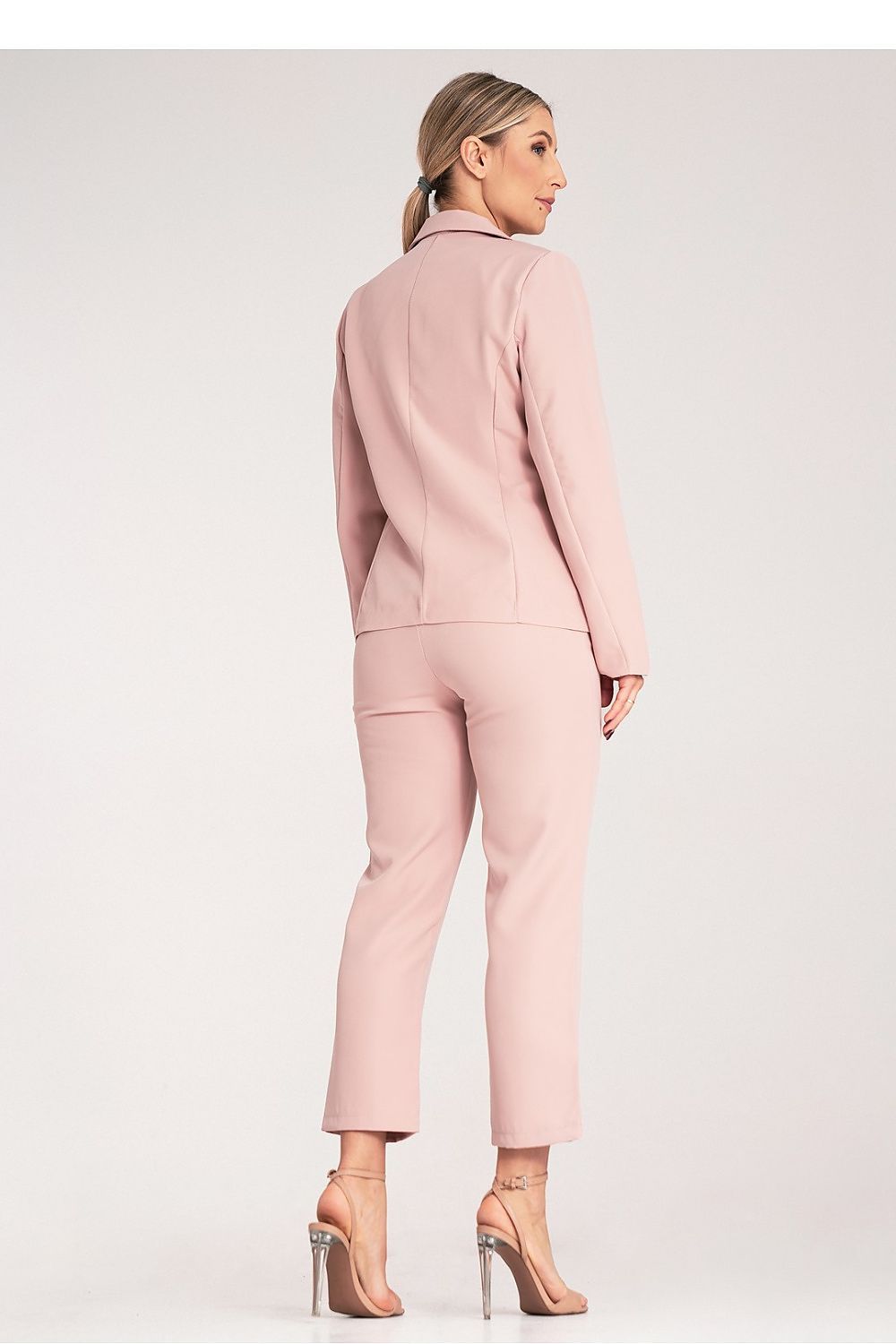 Woman wearing a pink suit on a white background
