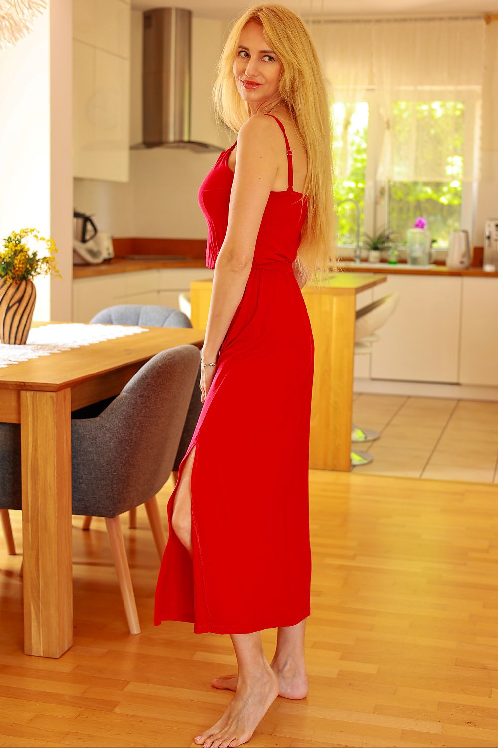 Woman in a red dress standing in a kitchen