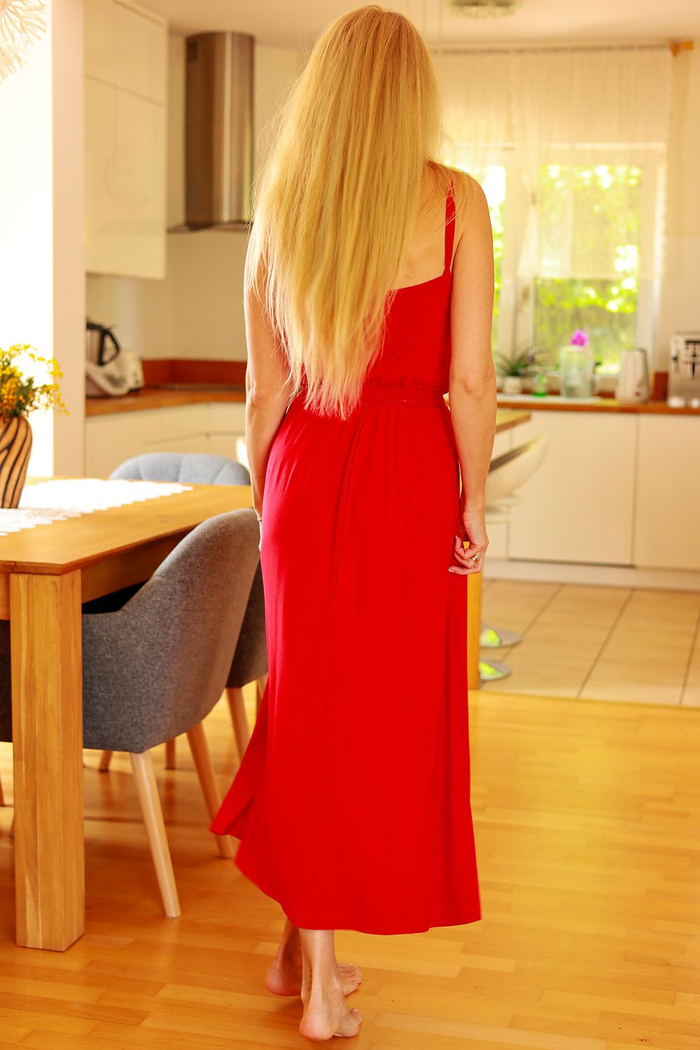 Woman in a red dress standing in a kitchen
