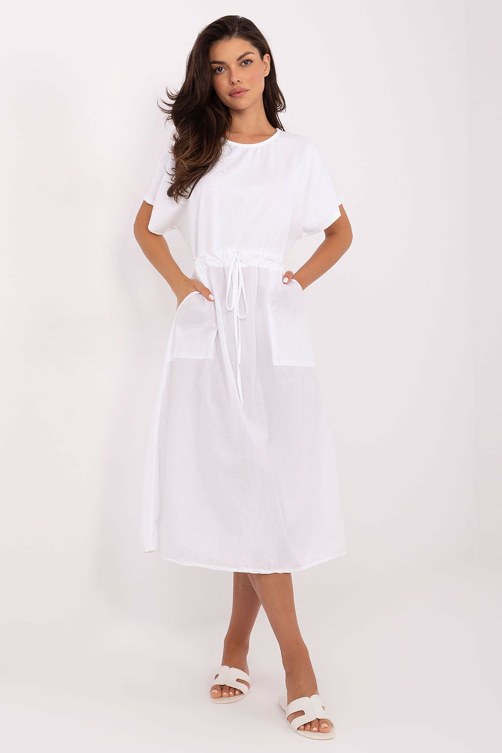 Woman wearing a white dress on a white background