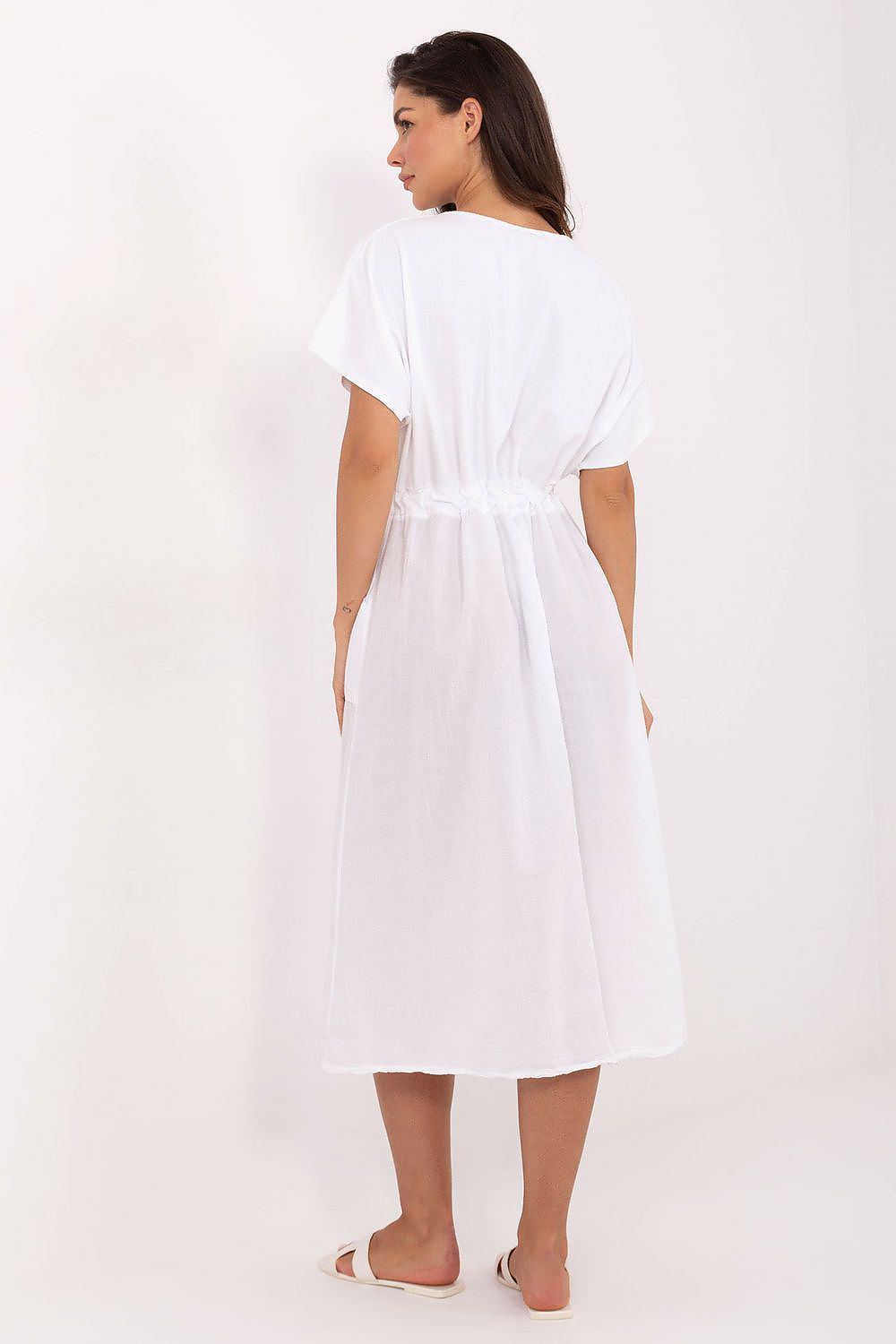Woman wearing a white dress on a white background