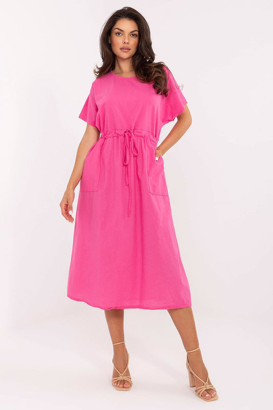 Woman wearing a bright pink dress on a white background