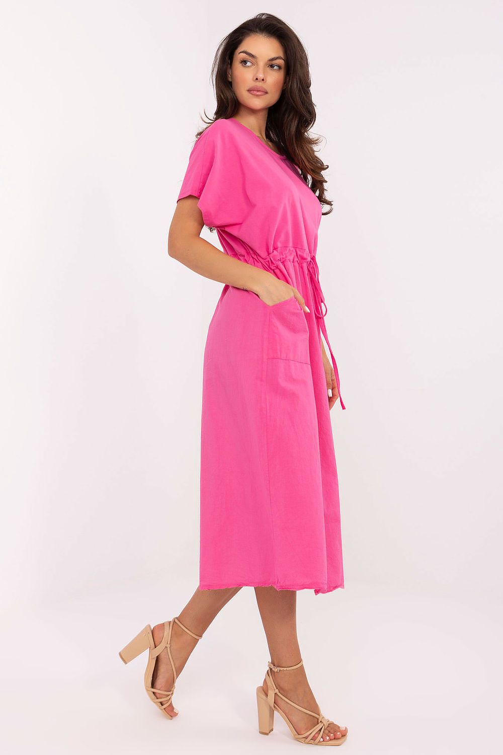 Woman wearing a pink dress on a white background