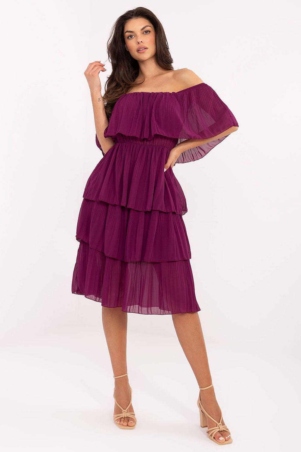 Woman wearing a purple off-shoulder dress on a white background