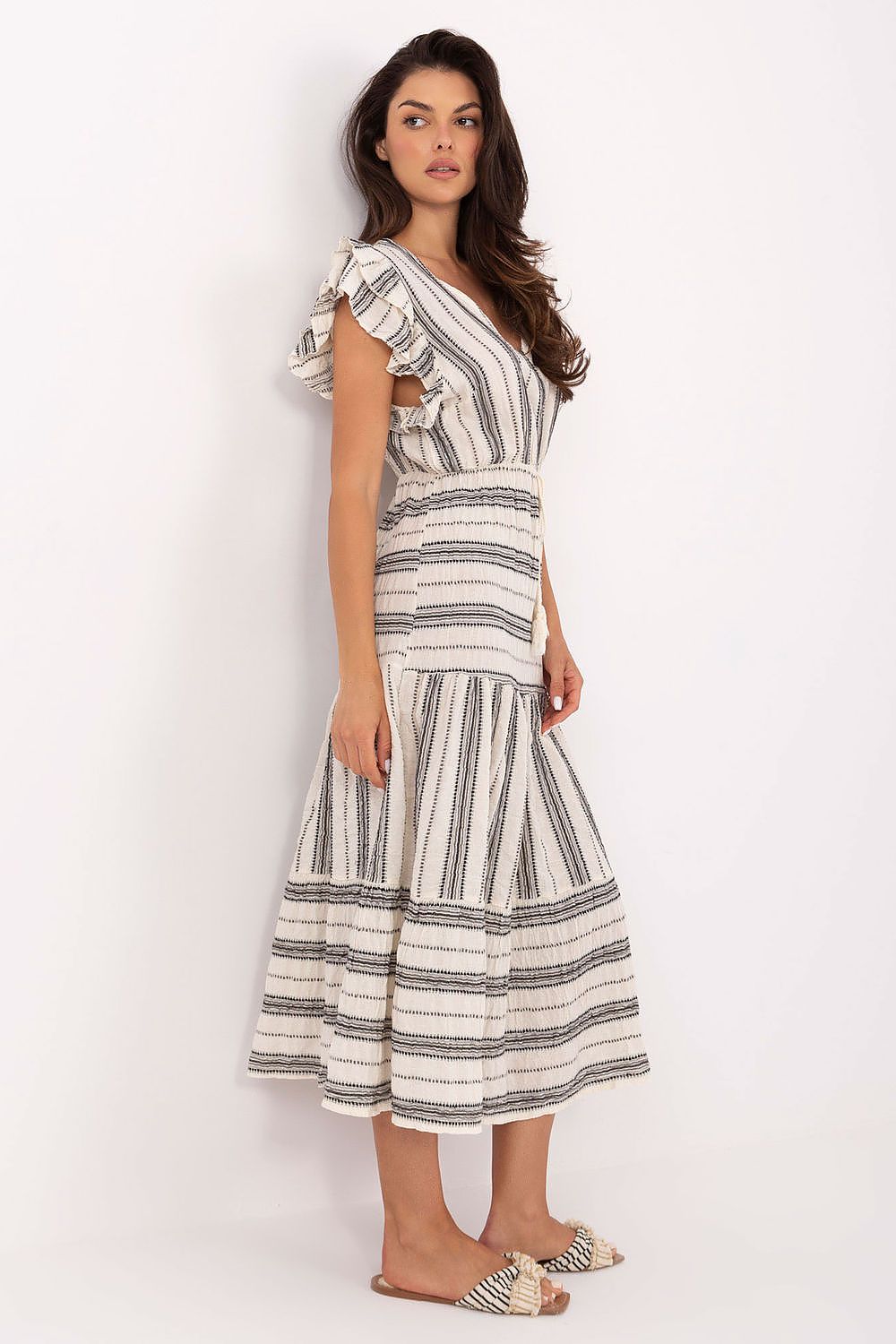 Woman wearing a striped dress on a white background