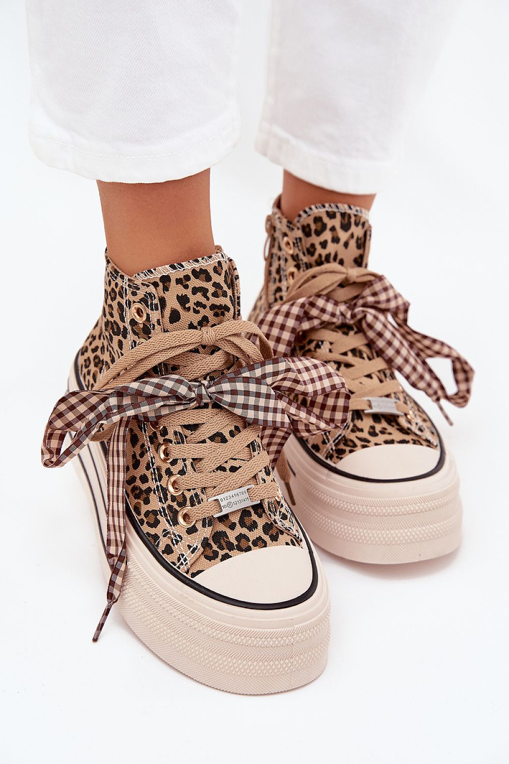 Top view – Lace-up sneakers with zipper fastening and feminine ribbon accent.