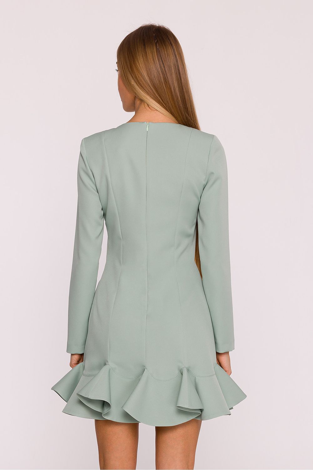 Light green dress with ruffled skirt worn by a model on a white background