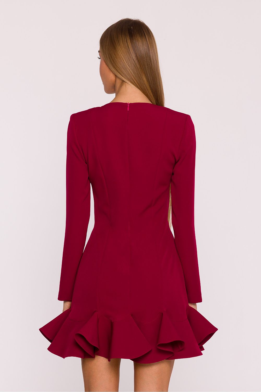Red dress with long sleeves and ruffled hem on a white background