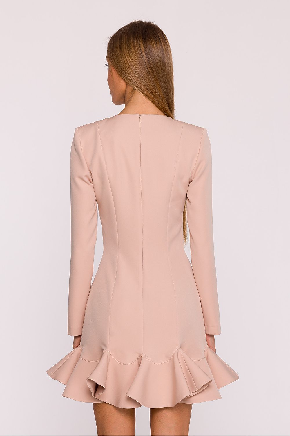 Beige dress with long sleeves and a ruffled skirt on a white background