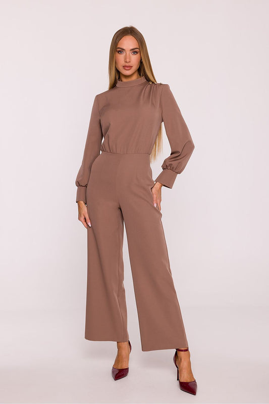 Woman wearing a brown jumpsuit on a white background