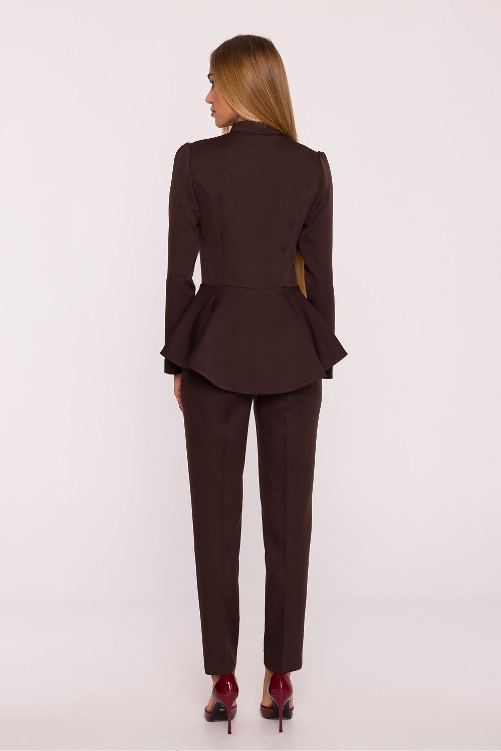 Woman wearing a brown suit on a white background