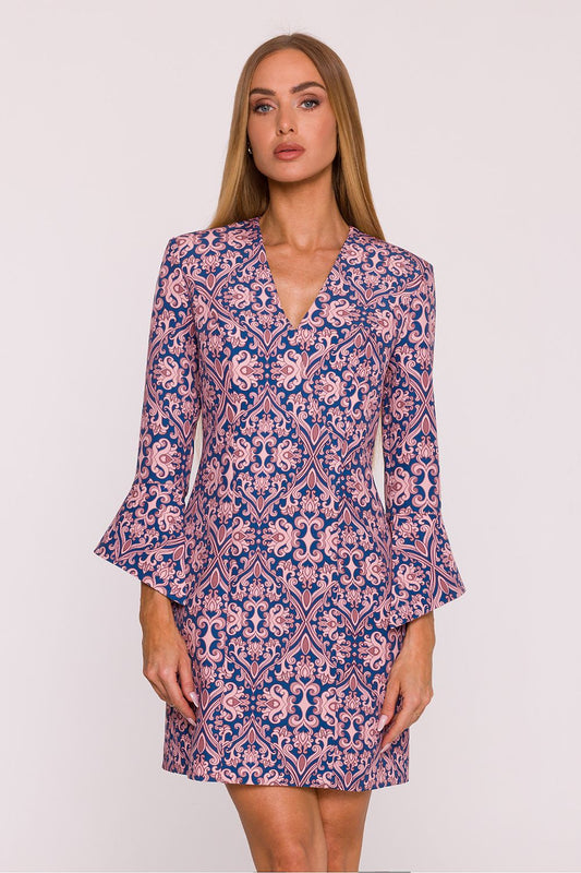 Woman wearing a patterned dress on a white background