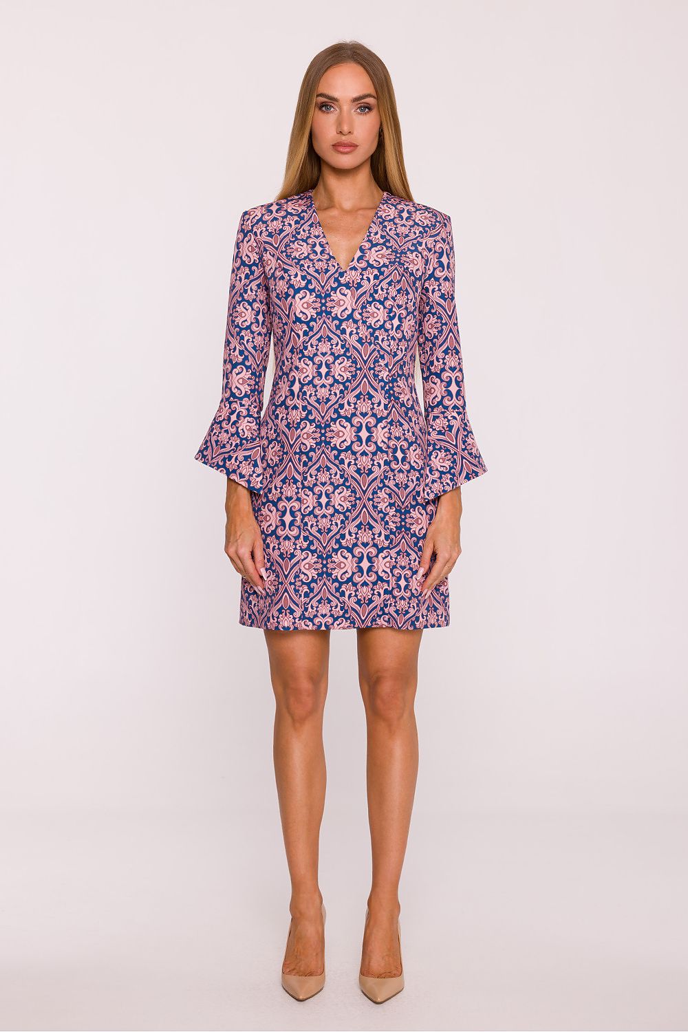 Woman wearing a patterned dress on a white background