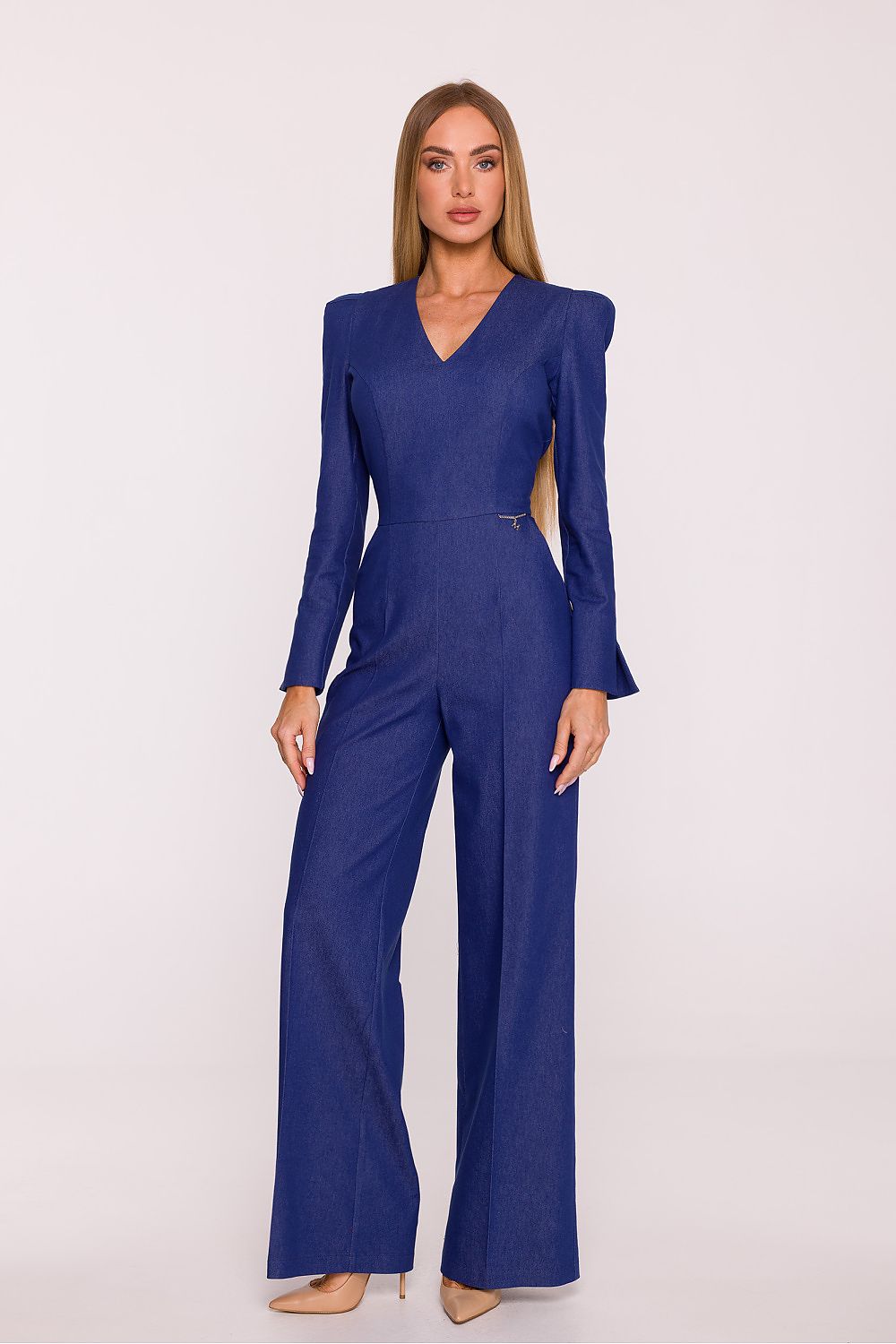 Woman wearing a blue jumpsuit on a white background