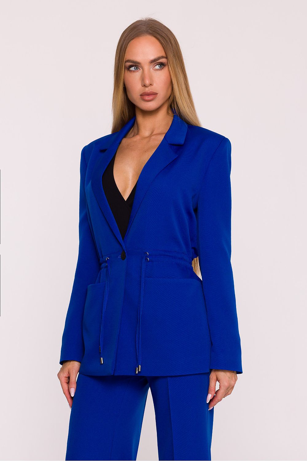 Woman wearing a blue suit with a plain background