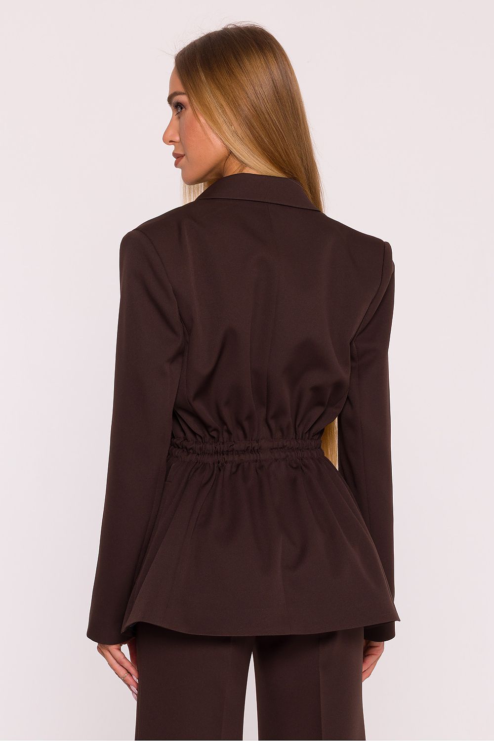 Woman wearing a brown jacket on a white background