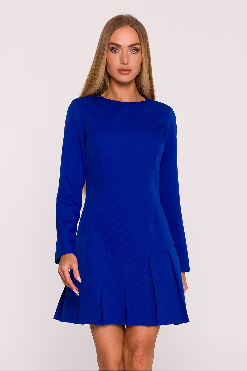 Woman wearing a blue dress against a white background