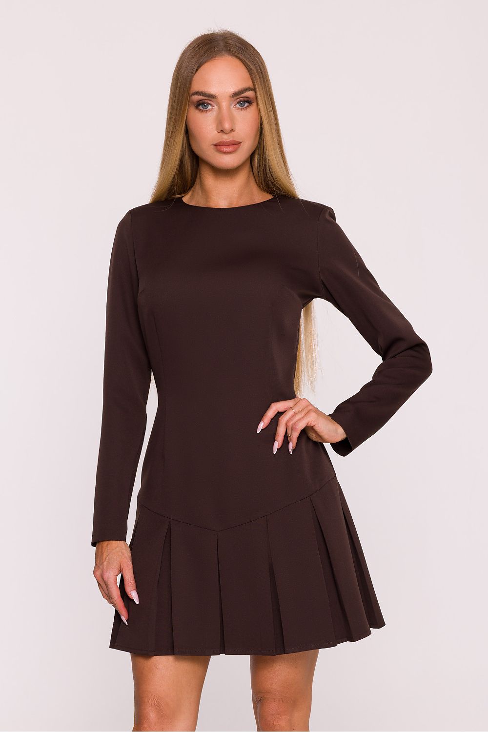 Woman wearing a brown dress against a white background