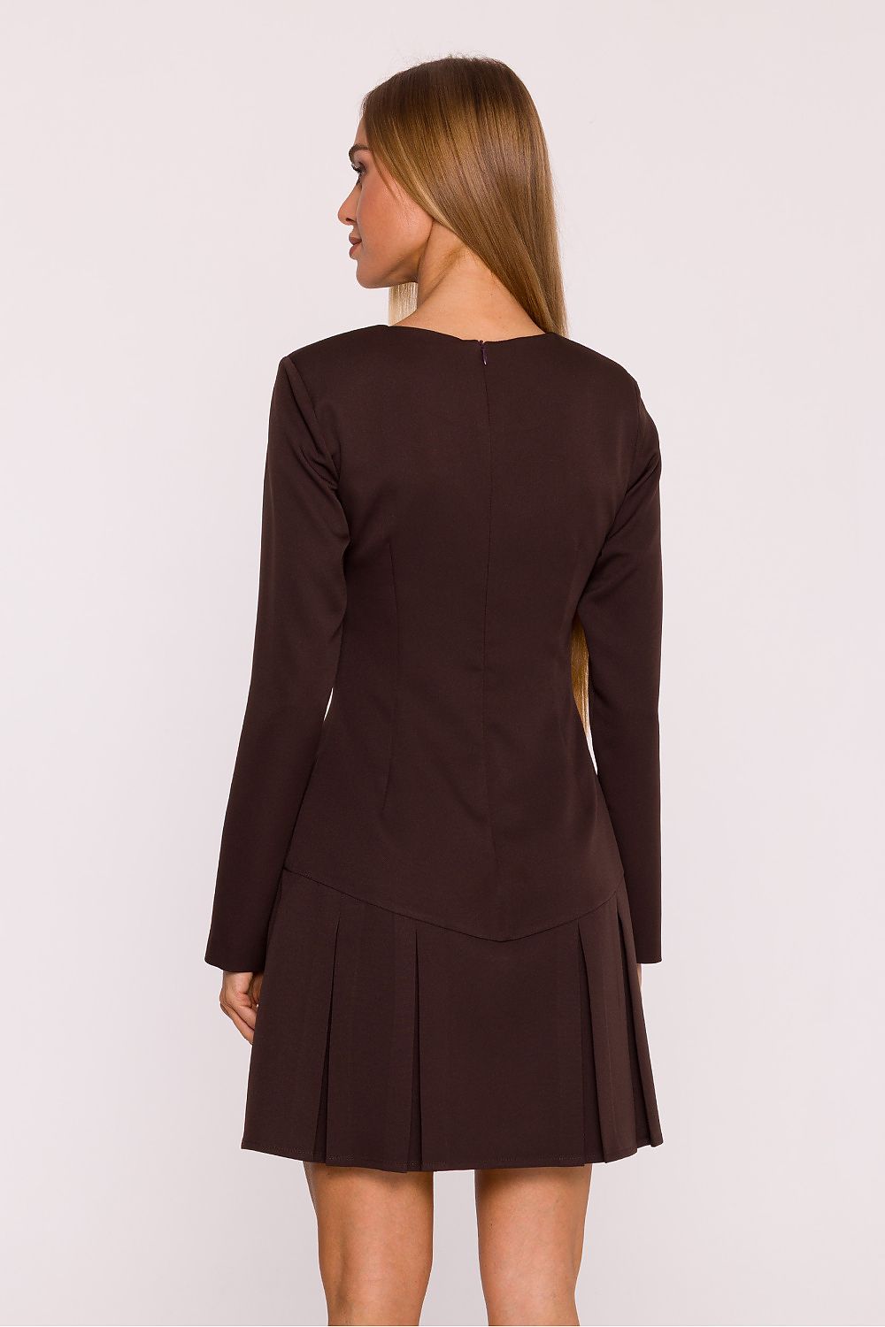 Woman wearing a brown dress with long sleeves on a white background