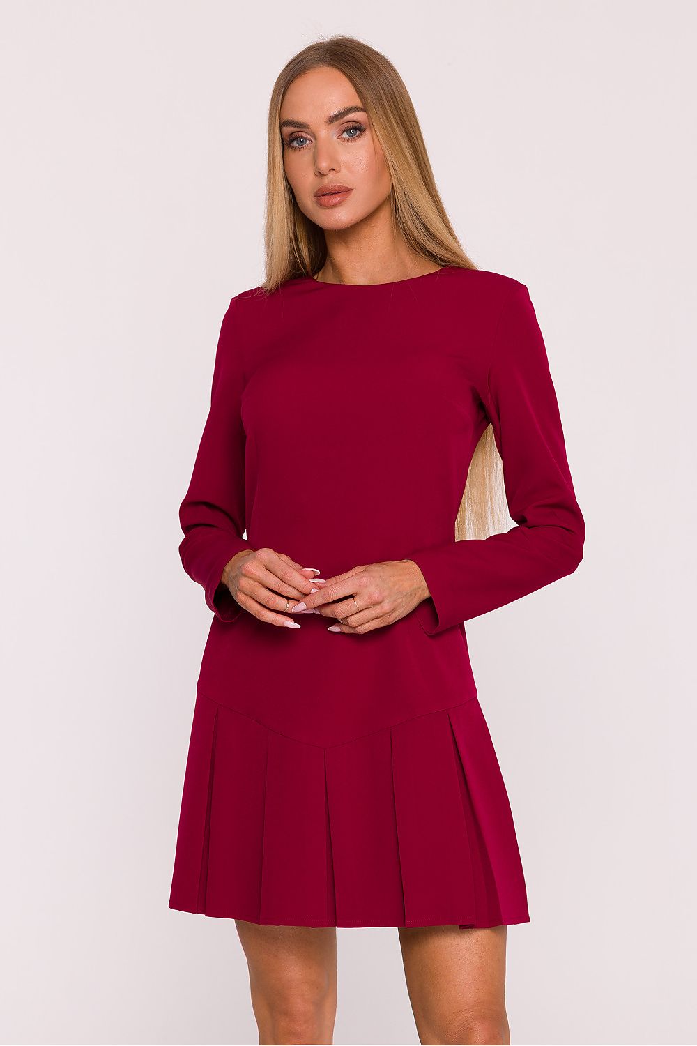 Woman wearing a red dress against a white background