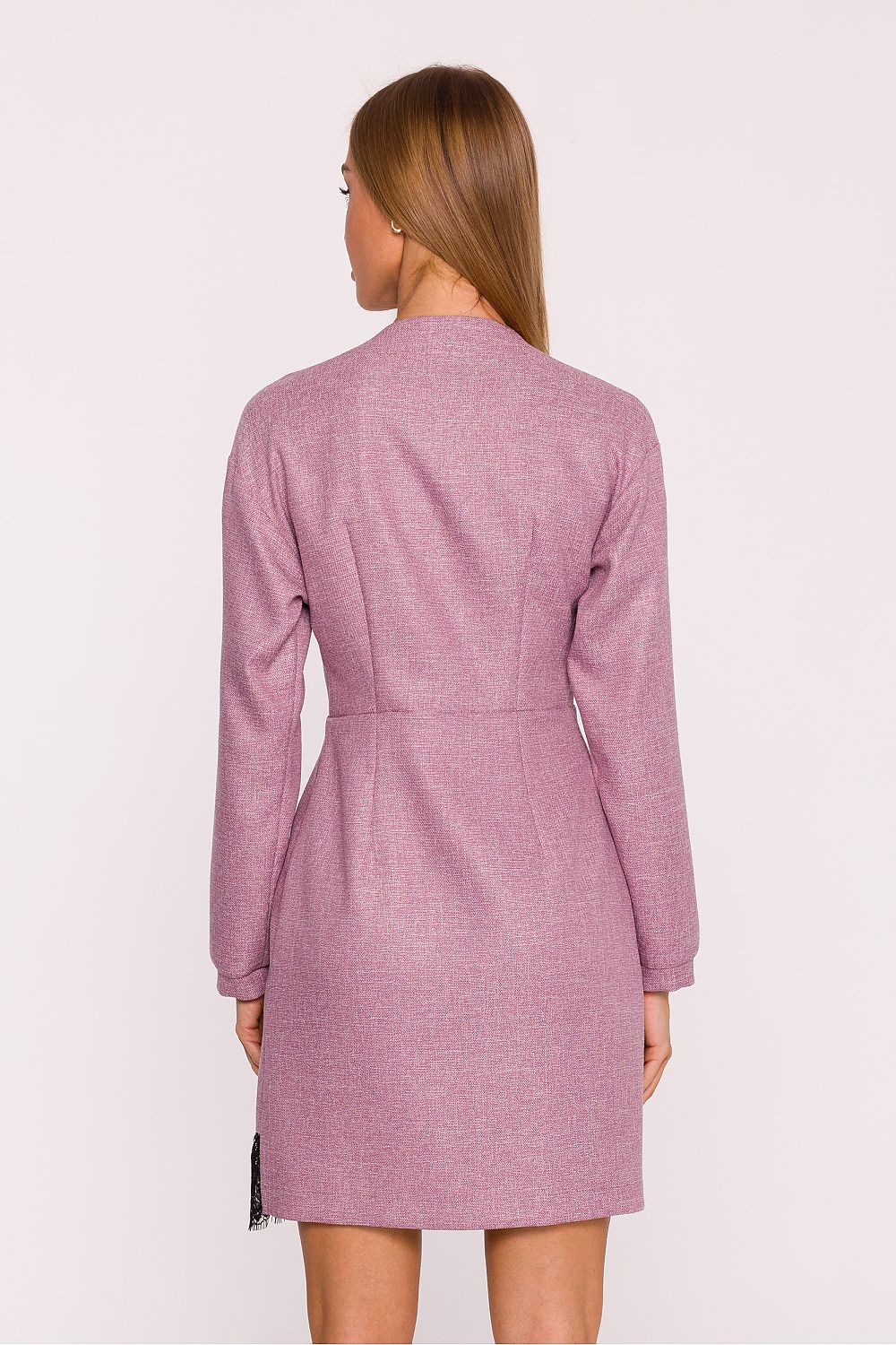 Woman wearing a pink checkered dress against a white background