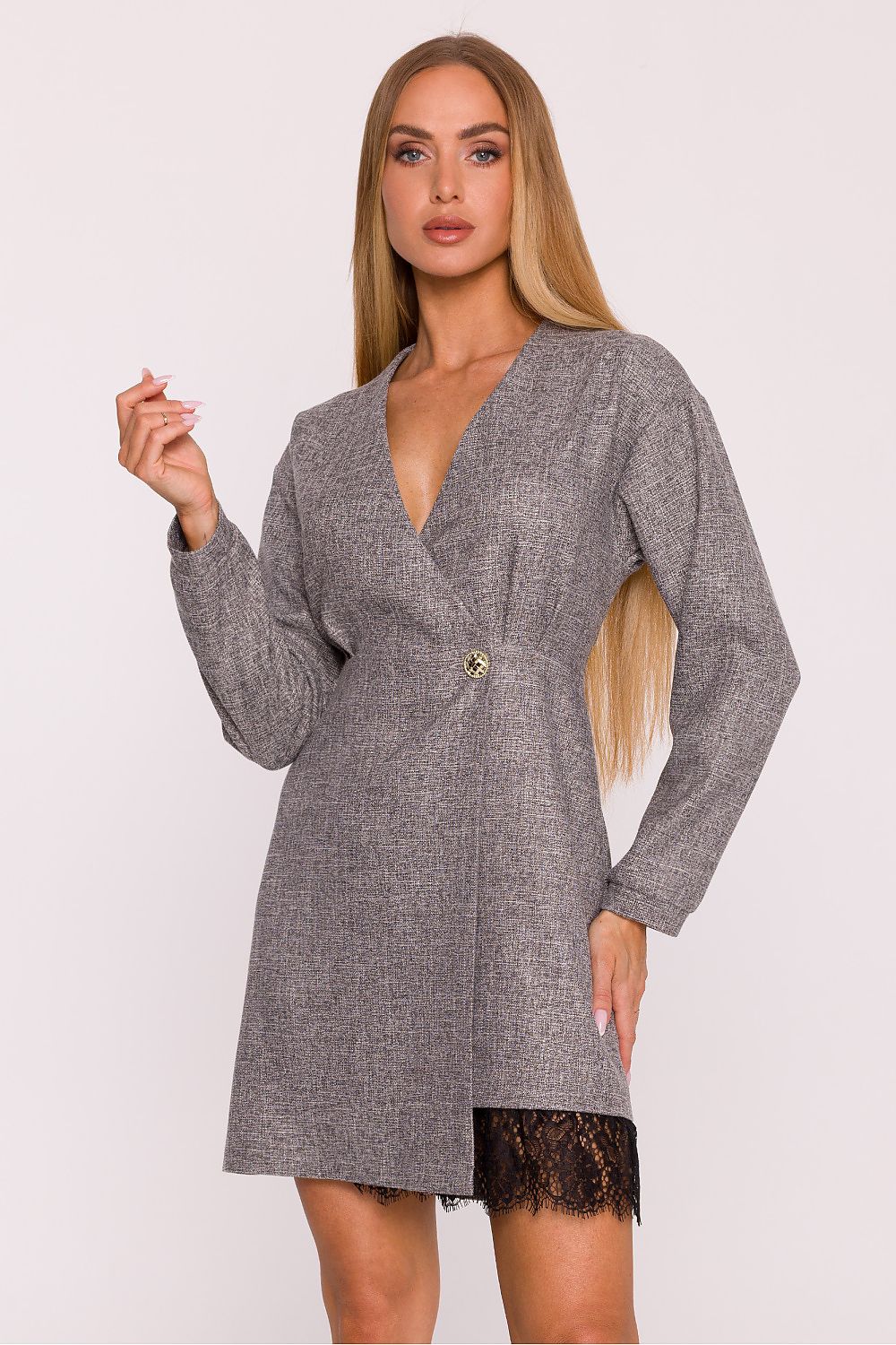 Woman wearing a gray wrap dress with lace hem on a white background