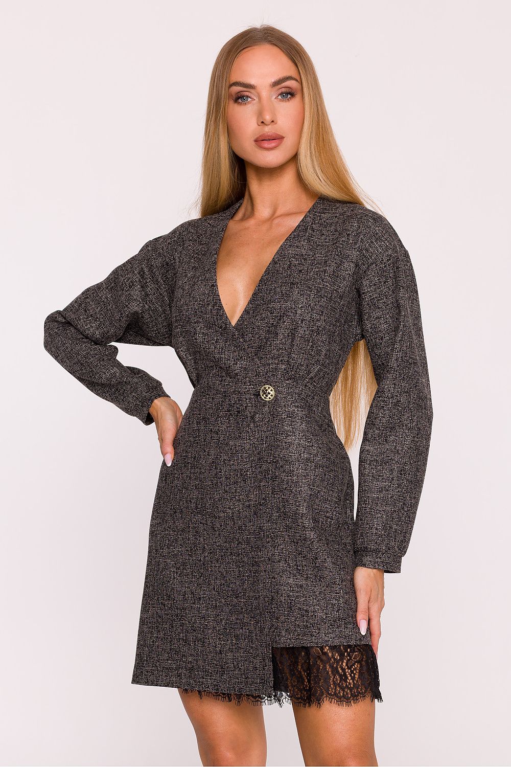 Woman wearing a dark gray dress with a lace hem on a white background