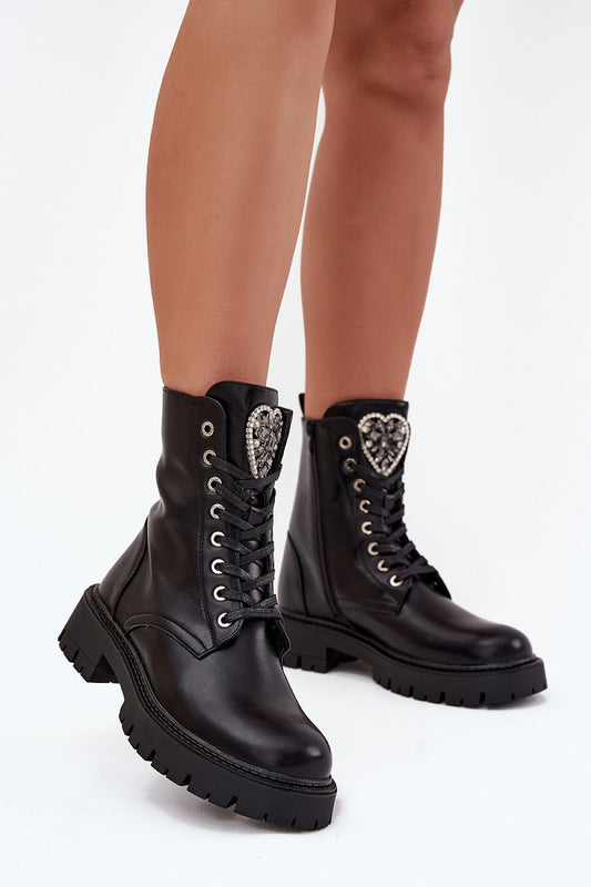 Side profile of black ankle boots showing flat heel and platform sole for comfort.