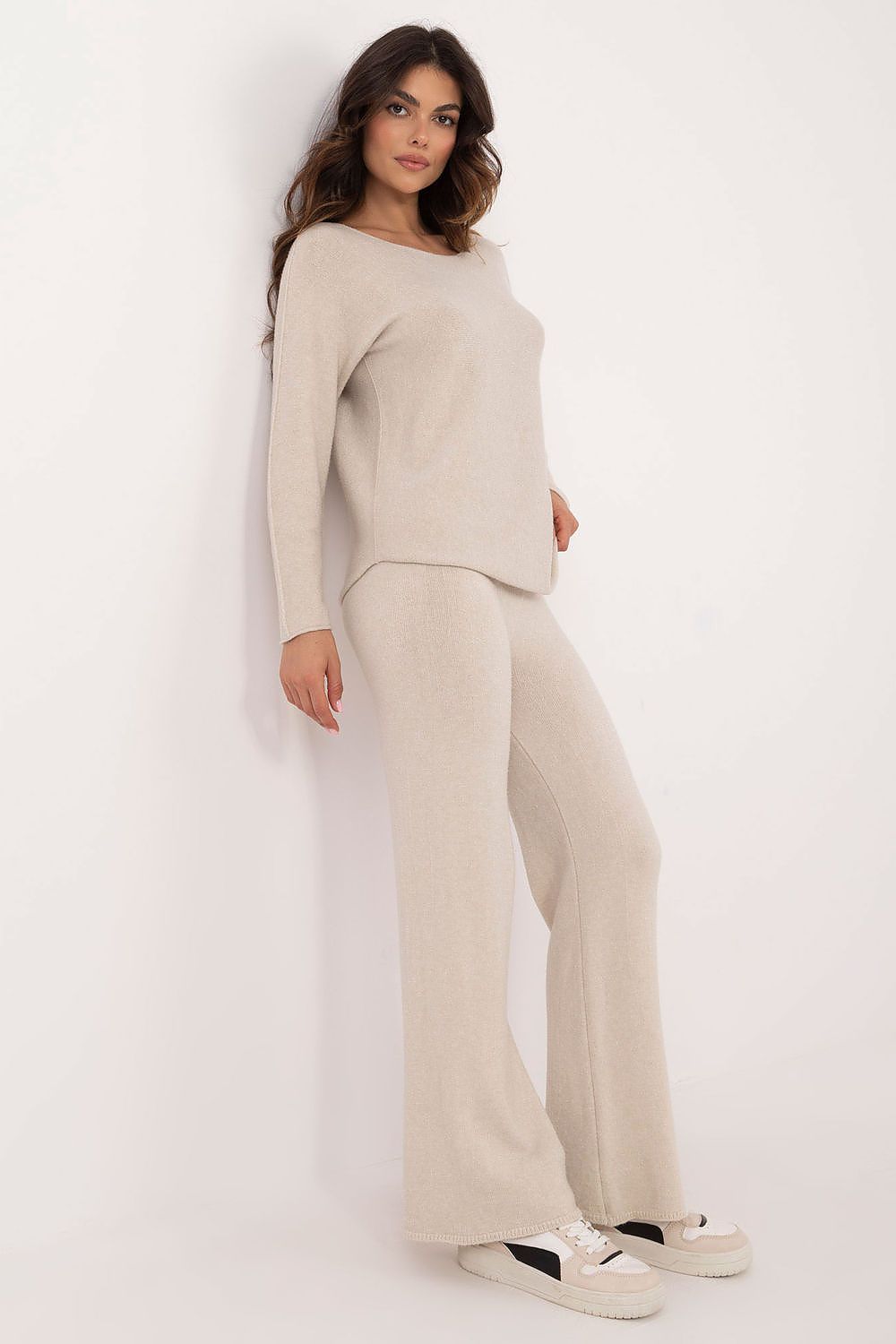Side angle of beige casual women’s sweater and pants set showing relaxed fit and smooth fabric
