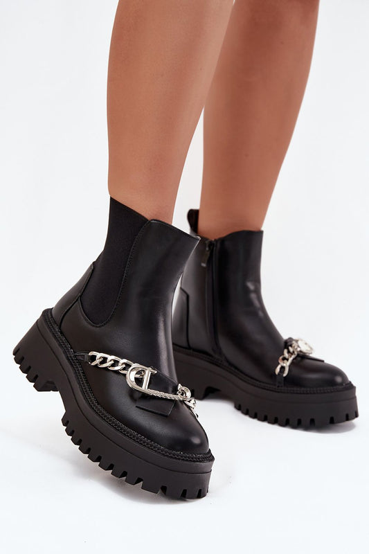 Front view of women’s eco leather ankle boots with decorative chain and buckle, platform sole, and fur lining.