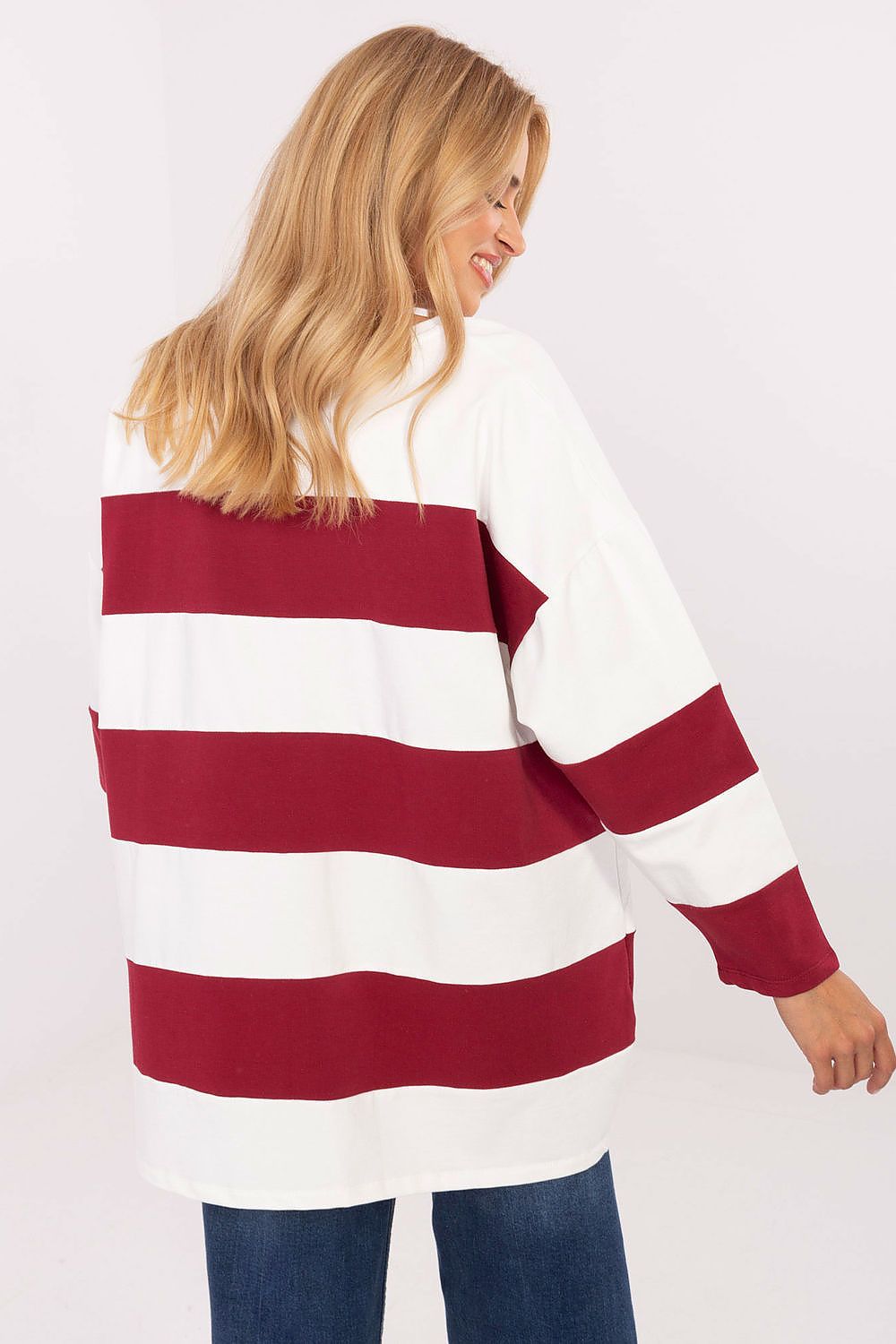 Woman wearing a red and white striped sweater on a white background