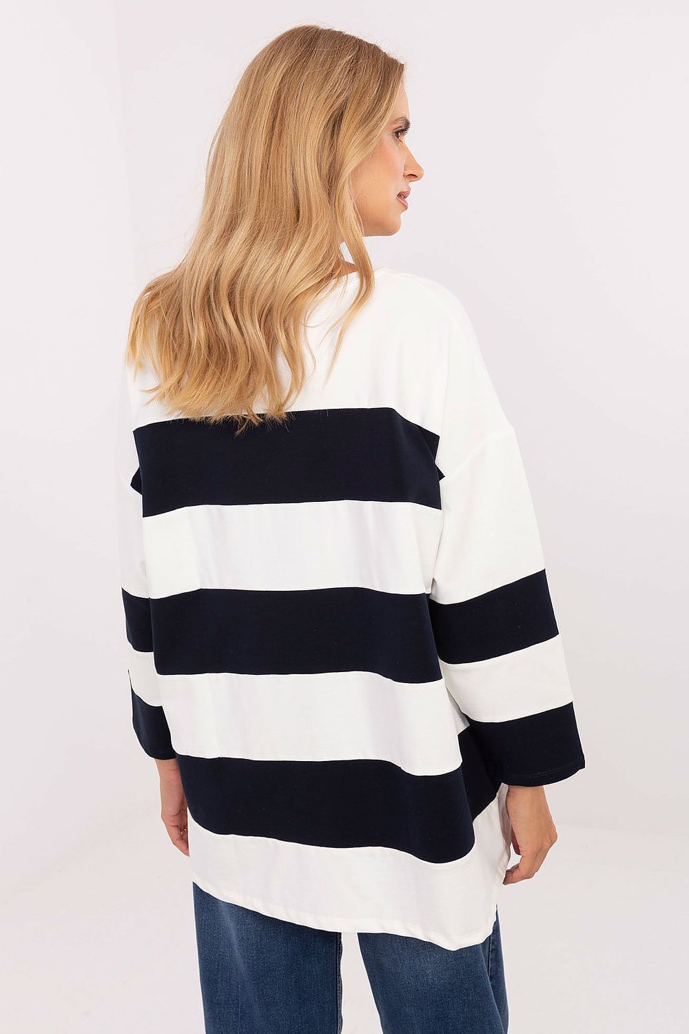 Woman wearing a black and white striped sweater on a white background