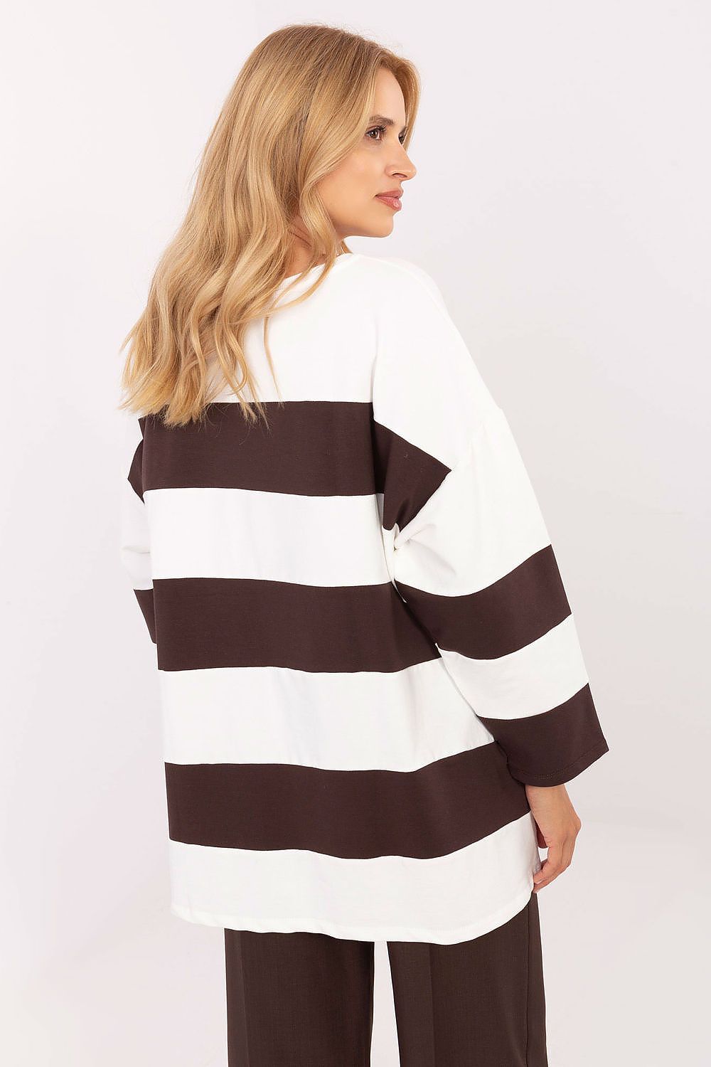 Woman wearing a black and white striped sweater on a white background