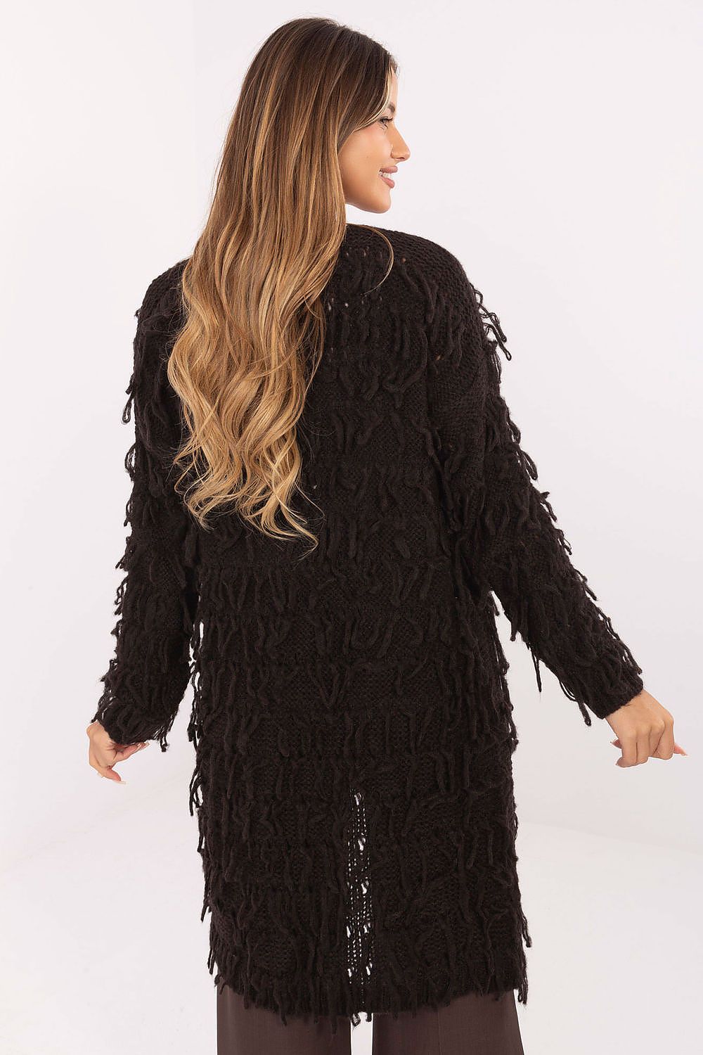  Back view of brown knit cardigan highlighting fringed detailing.