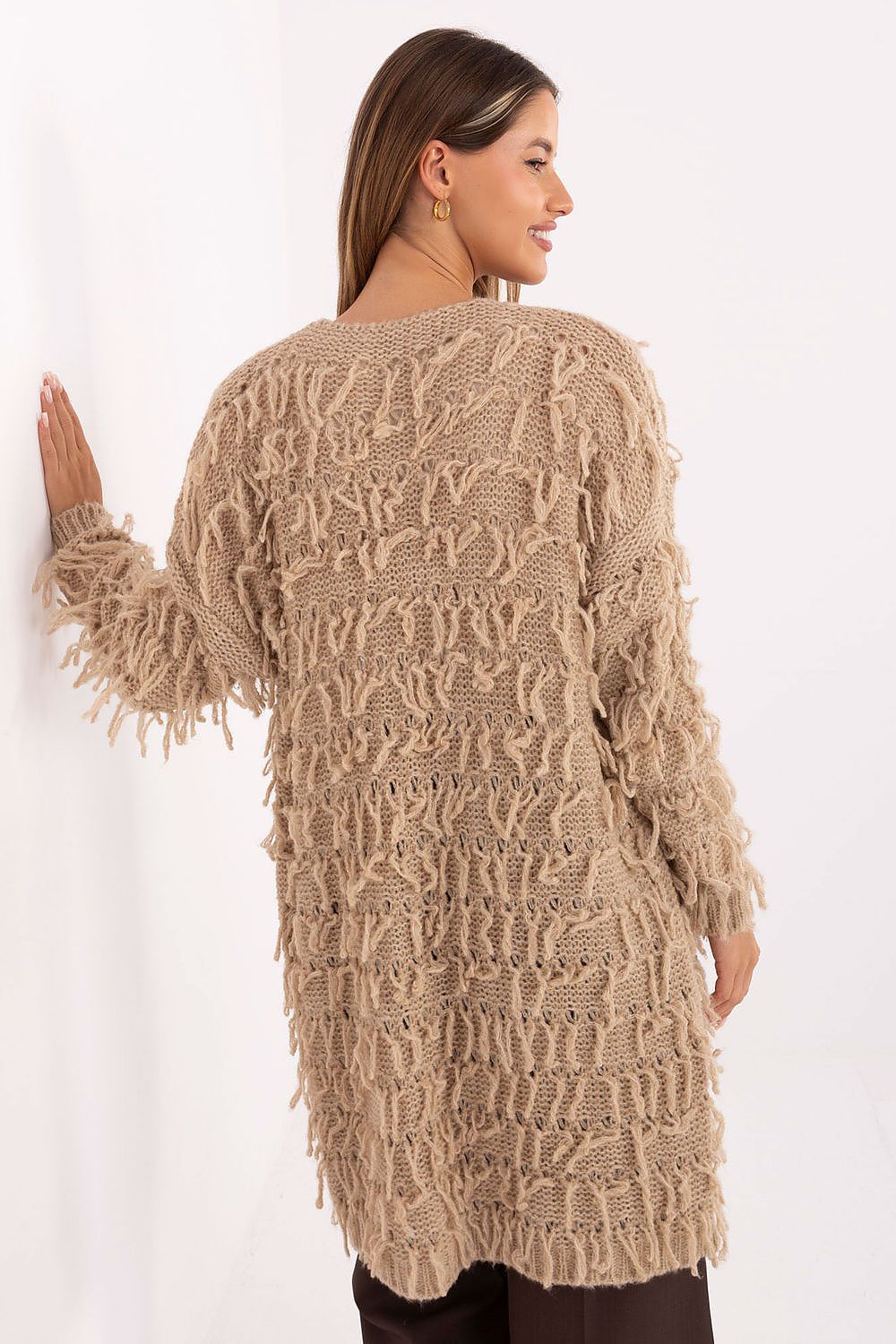 Back view of beige knit cardigan highlighting longline fringed design