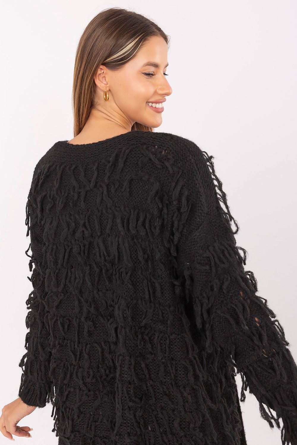 Back view of black cardigan highlighting fringed knit texture.