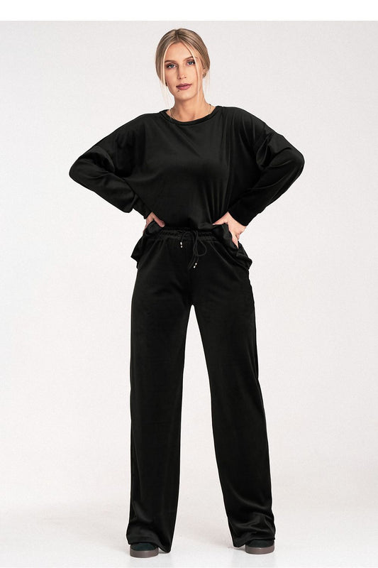 Woman wearing a black outfit on a white background
