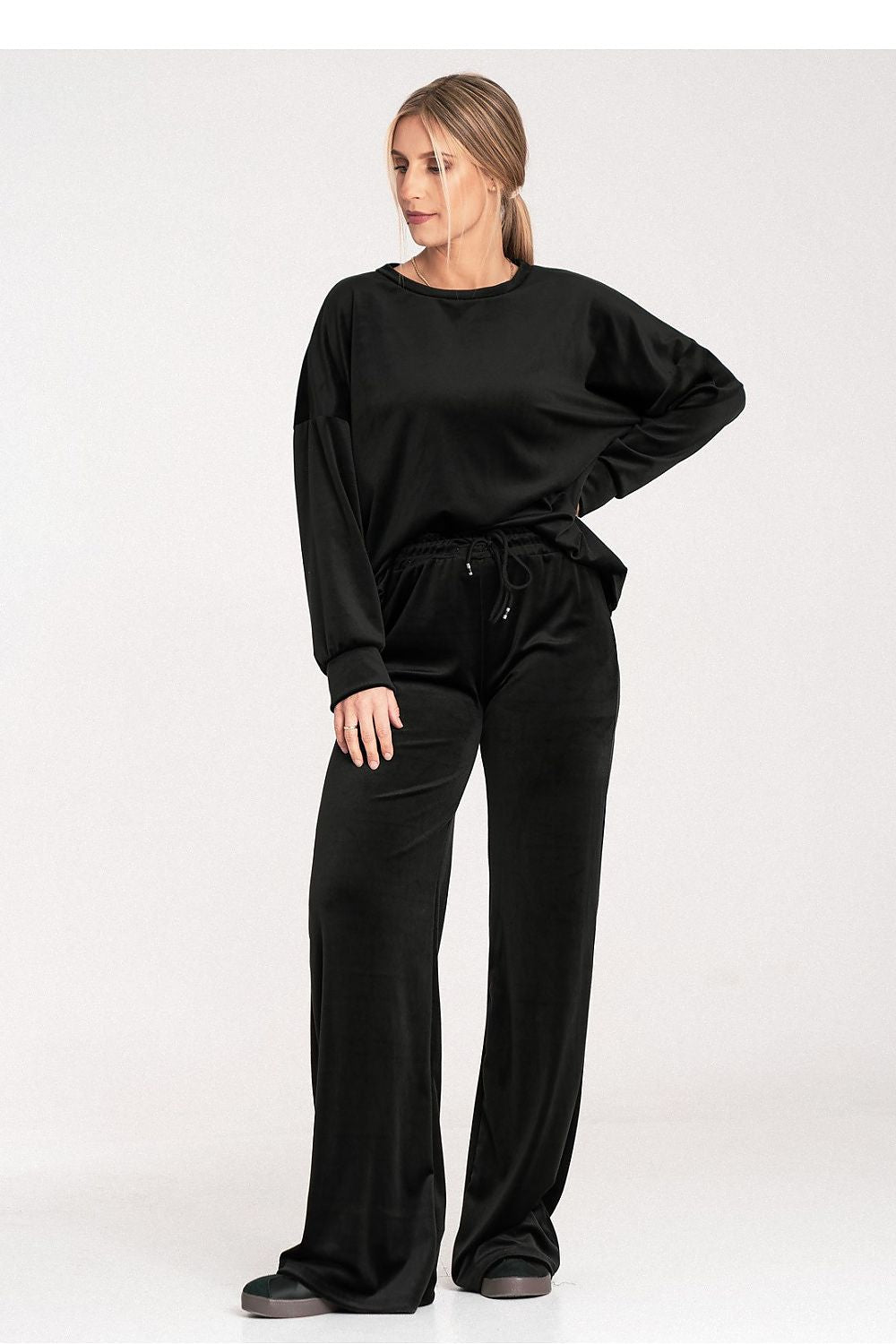 Woman wearing a black outfit on a white background